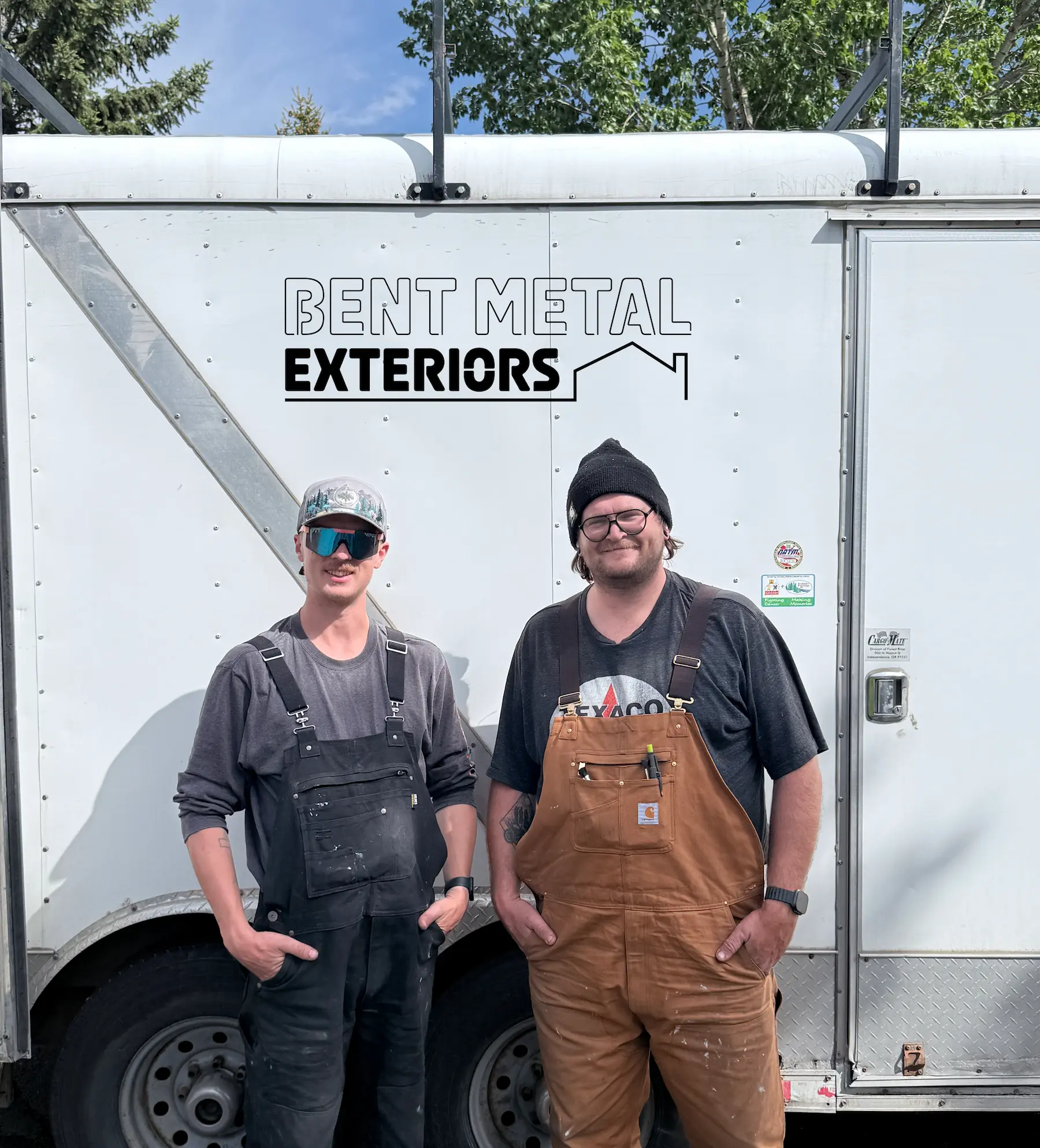 The Bent Metal Exteriors team standing in front of their company trailer in Calgary